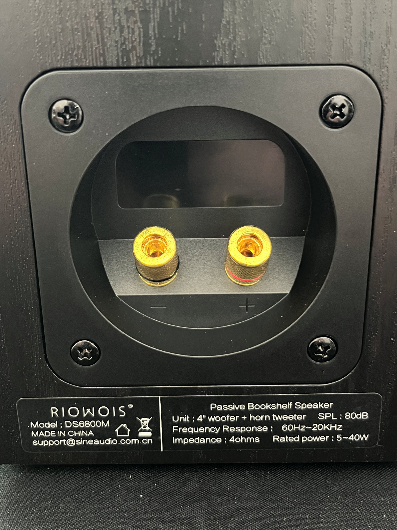 Closeup of the original speaker wire terminal plate on the back of the cabinet